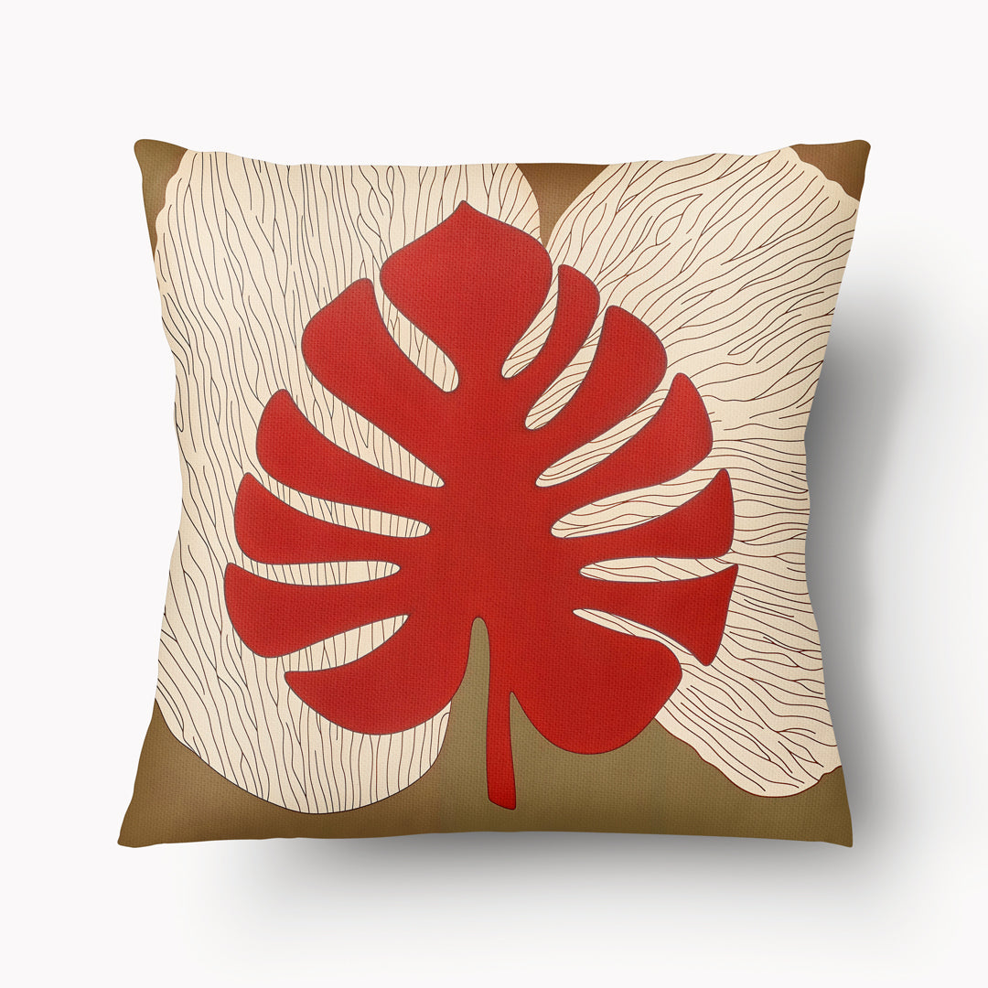 Coussin d'ambiance Mzelle Design aspect Lin imprimé avec des Monsteras Deliciosa enlacées sur fond de composition graphique, écru, rouge et marron cacao.