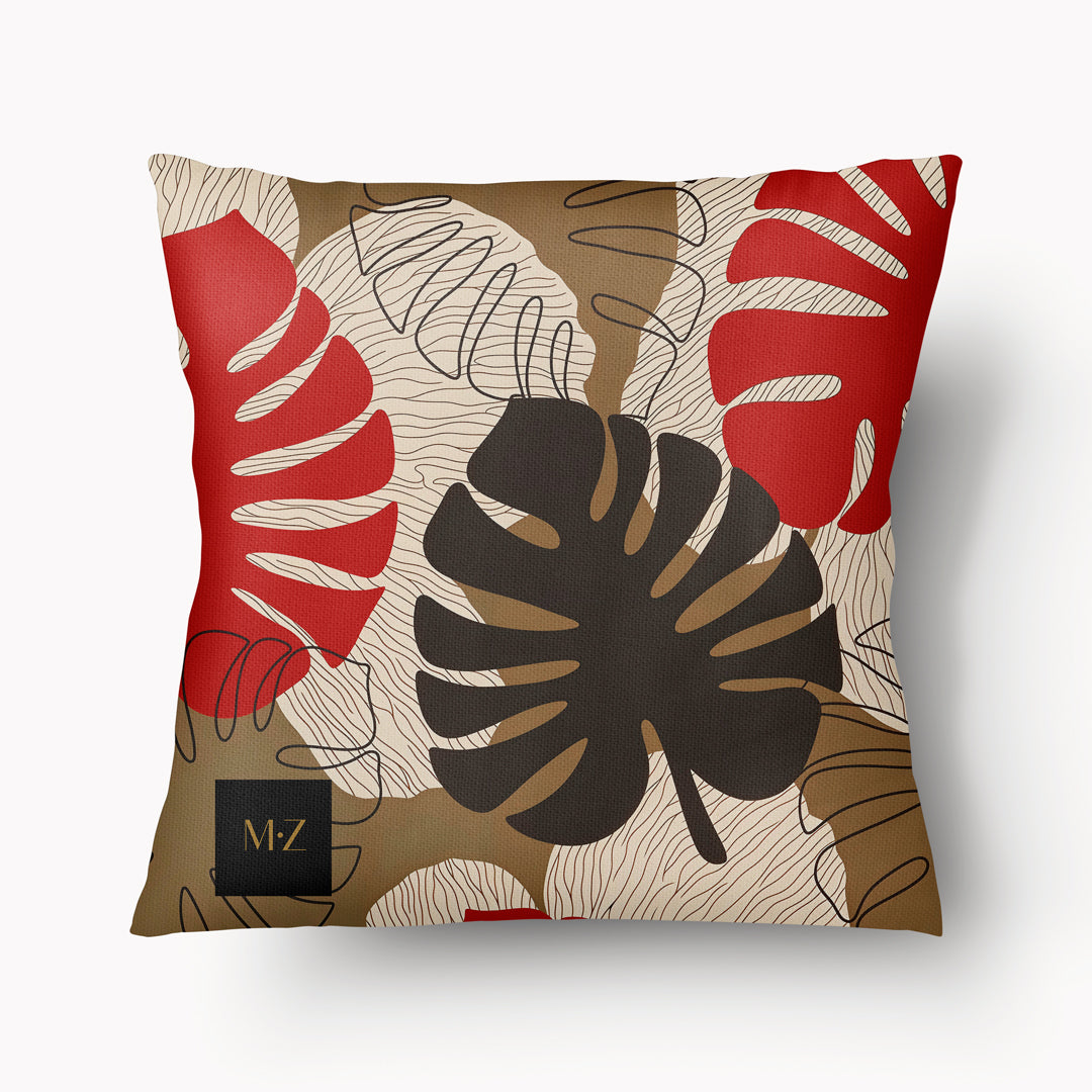 Coussin d'ambiance Mzelle Design aspect Lin imprimé avec des Monsteras Deliciosa enlacées sur fond de composition graphique, écru, rouge et marron cacao.