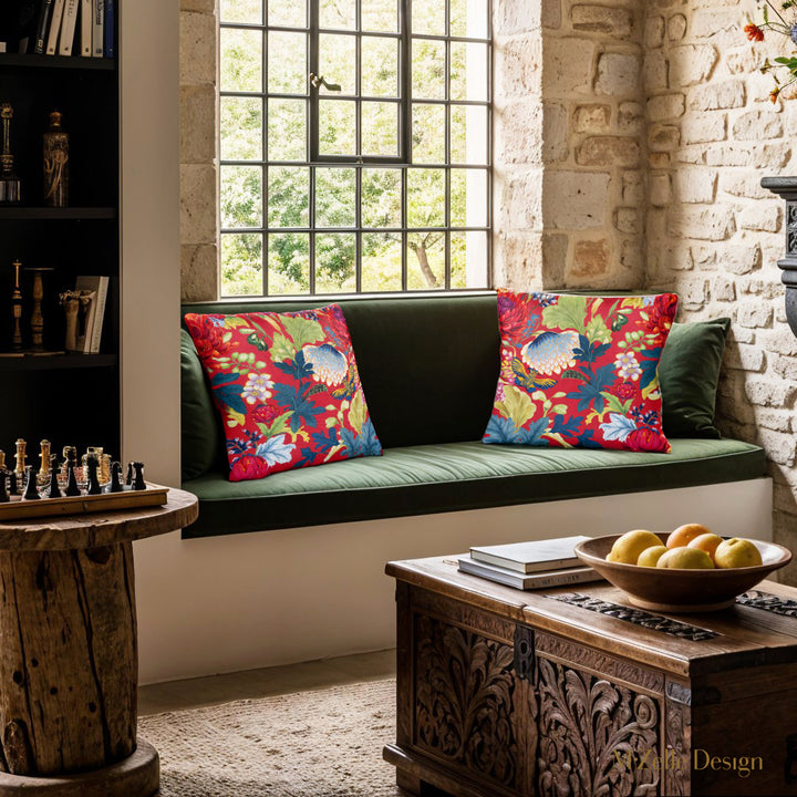 décoration intérieur d'une maison en vieilles pierres avec un canapé orné de 2 coussins rouges mzelle design