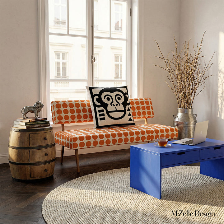 décoration d'intérieur moderne avec un canapé imprimé motifs pois orangeset orné d'un coussin graphique tête de singe , table basse bleu, plantes verte.
