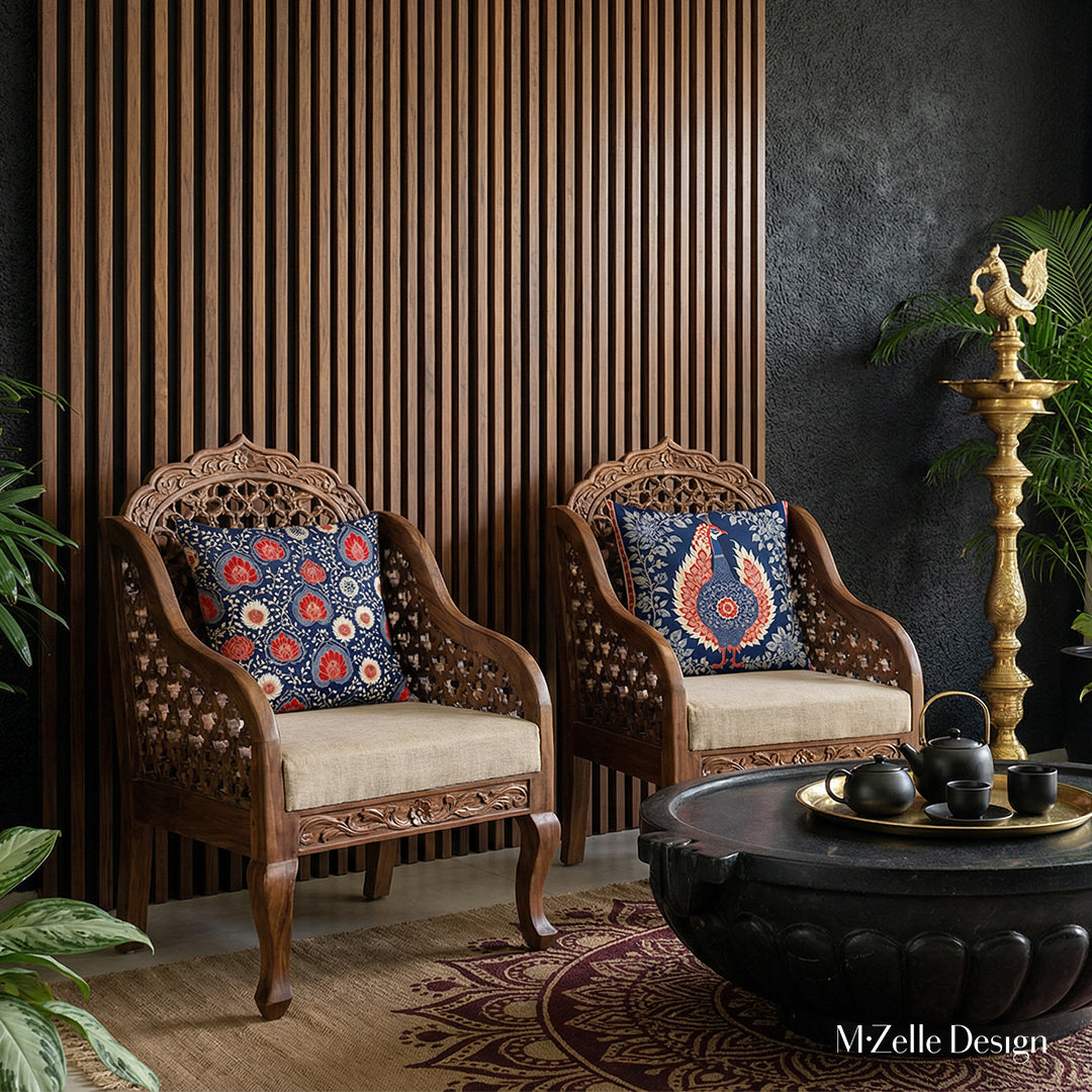 Décoration d'intérieur raffinée de style indien, fauteuils en bois ornés de Coussin Mzelle Design rouge et bleu sur fond de mur végétal