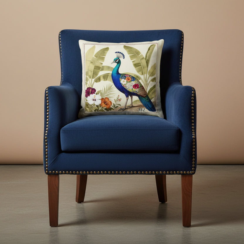 Photographie professionnelle qualité studio, extrêmement détaillée et de haute qualité d'un coussin mzelle design motif paon bleu, disposé sur un fauteuil crapaud en velours mat bleu nuit, rivet en laiton, bois de noyer, sans accoudoirs, disposée dans un décor minimaliste, neutre beige.