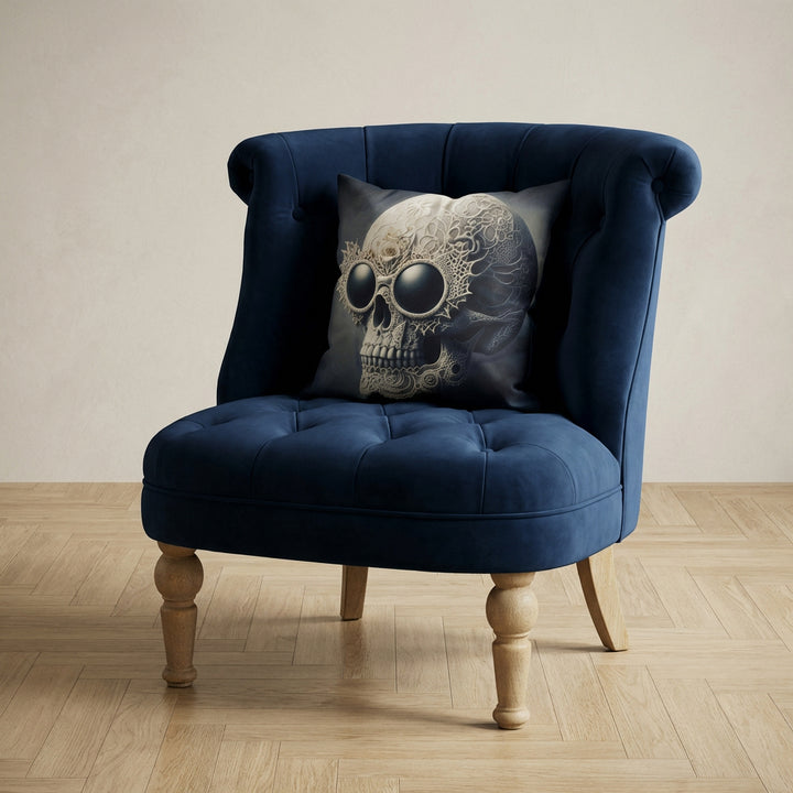 photographie professionnelle décoration de mobilier, fauteuil épuré de style crapaud bleu nuit capitonné avec un coussin mzelle design motif tête de mort baroque posé dessus, placé dans un décor neutre.