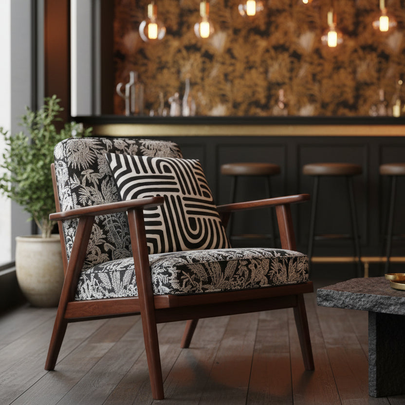 bar lounge caribéen à la décoration intimiste et au design moderne, gros plan sur un fauteuil triangulaire en bois orné d'un coussin carré, table basse en roche noire brute.